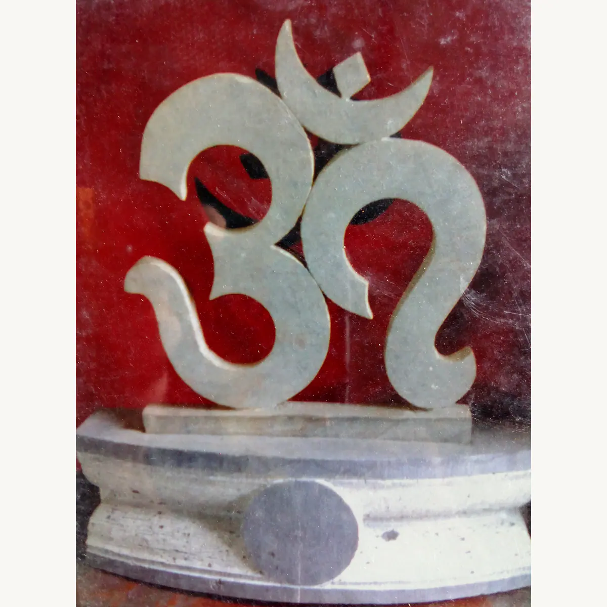 Carved OM stone symbol shown during workshop finishing